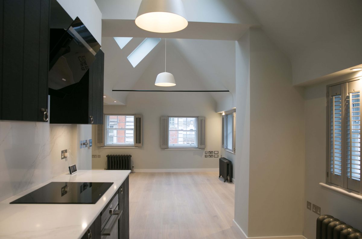 modern and classic black and white kitchen, black cabinets and sink, white walls