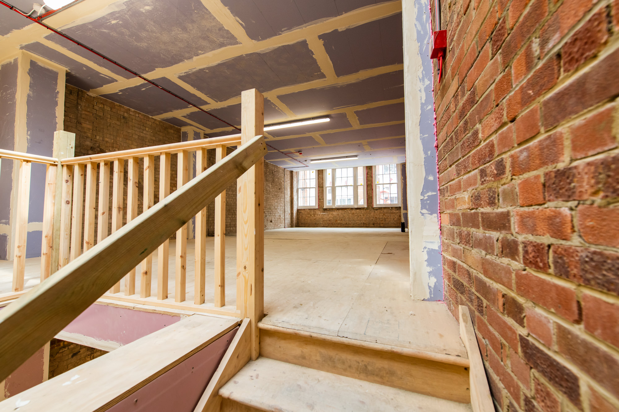 brick walls and wooden second floor